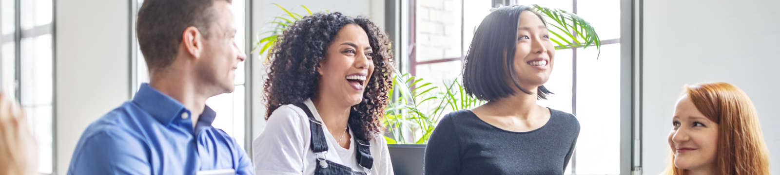 A group of business team members smiling and conversing